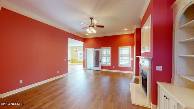 unfurnished living room with ceiling fan, light hardwood / wood-style flooring, and crown molding