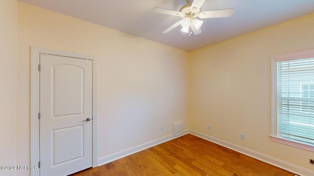 spare room with ceiling fan and light wood-type flooring