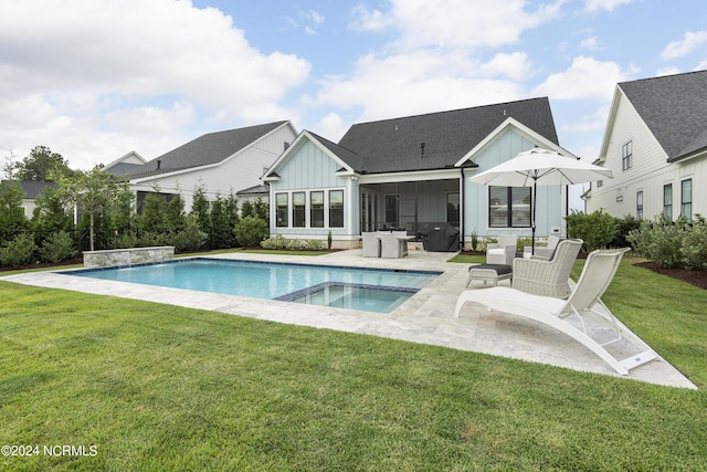 back of property with a patio, a yard, and a sunroom