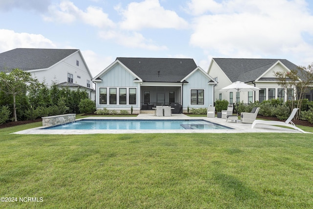 back of property featuring pool water feature, a patio area, and a lawn