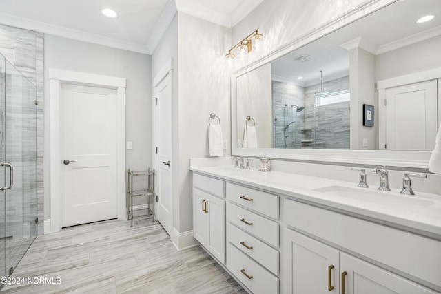 bathroom featuring ornamental molding, vanity, and a shower with shower door