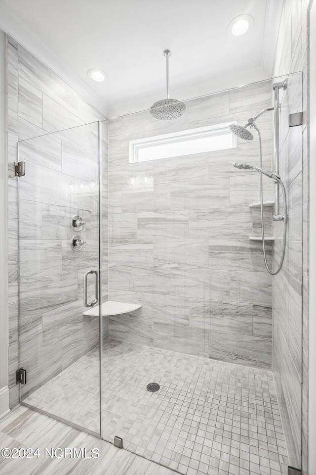 bathroom with a shower with door