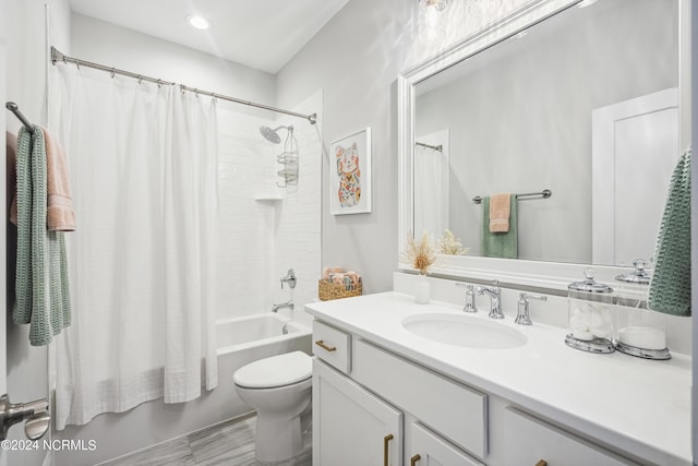 full bathroom featuring toilet, shower / bath combination with curtain, and vanity