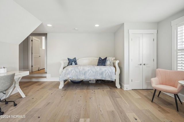 bedroom with a closet and light hardwood / wood-style flooring