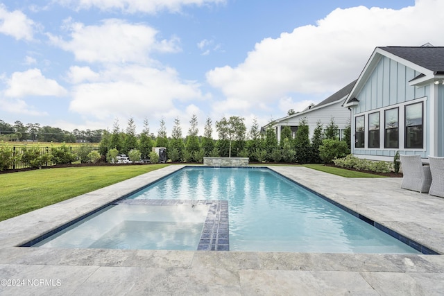 view of pool featuring a yard, an in ground hot tub, and a patio