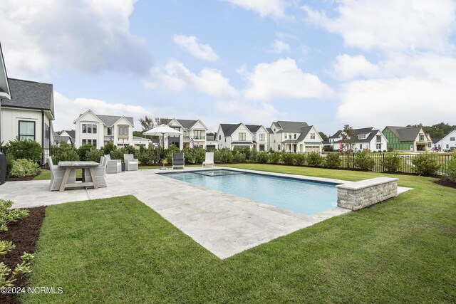 view of swimming pool with a patio and a lawn