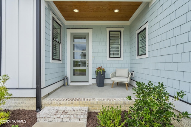 view of exterior entry featuring a porch