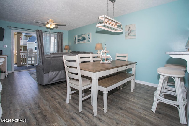 dining space featuring a textured ceiling, ceiling fan, and dark hardwood / wood-style flooring