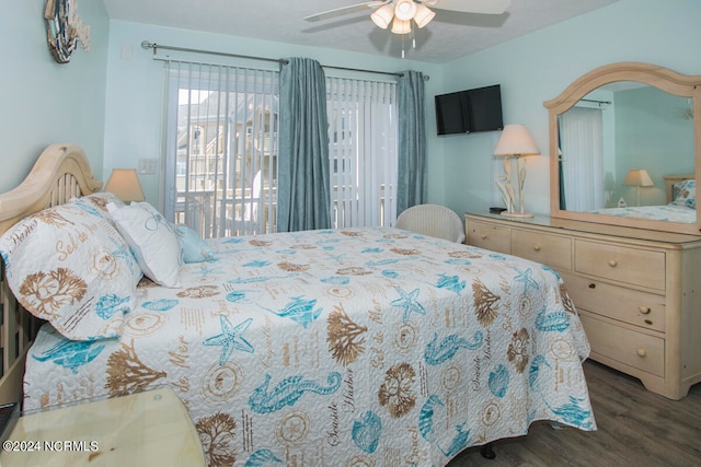 bedroom featuring ceiling fan, dark hardwood / wood-style floors, and access to exterior