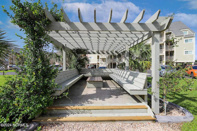 view of patio featuring a pergola and a deck