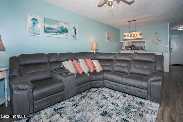 living room with ceiling fan, hardwood / wood-style flooring, and a textured ceiling