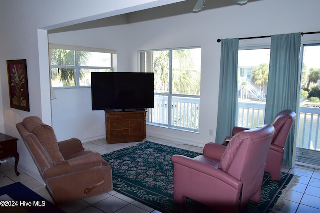 living room with ceiling fan and light tile patterned flooring