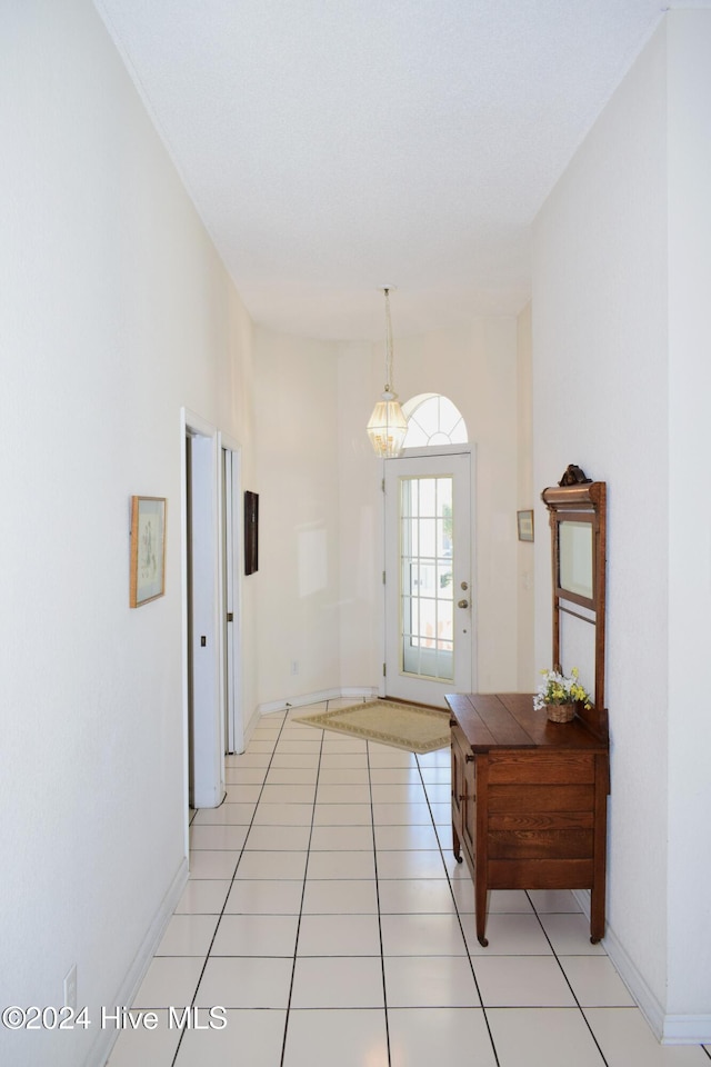 doorway to outside with light tile patterned floors