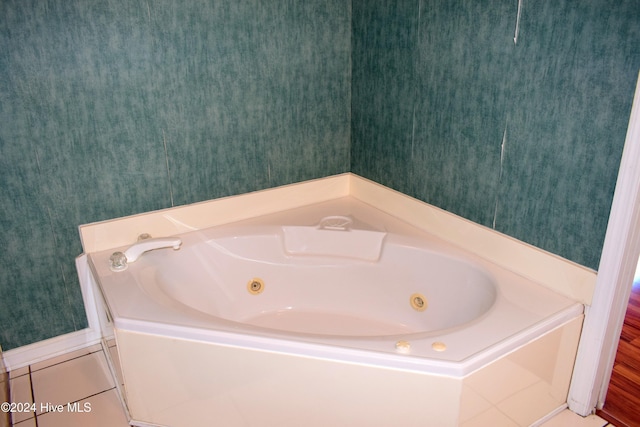 bathroom featuring tile patterned flooring and a bath