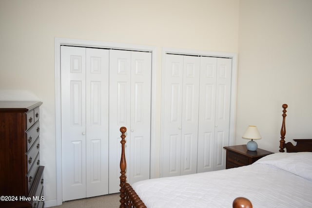 bedroom featuring carpet floors and two closets