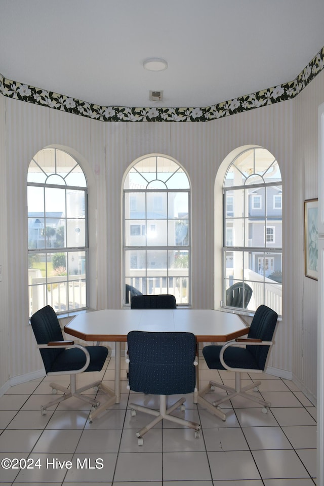 dining area with breakfast area and light tile patterned floors