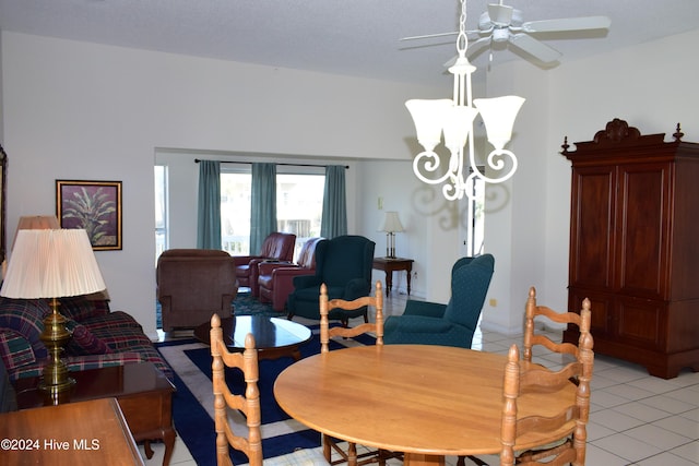 tiled dining room with ceiling fan with notable chandelier