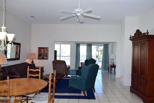 tiled living room featuring ceiling fan and a textured ceiling