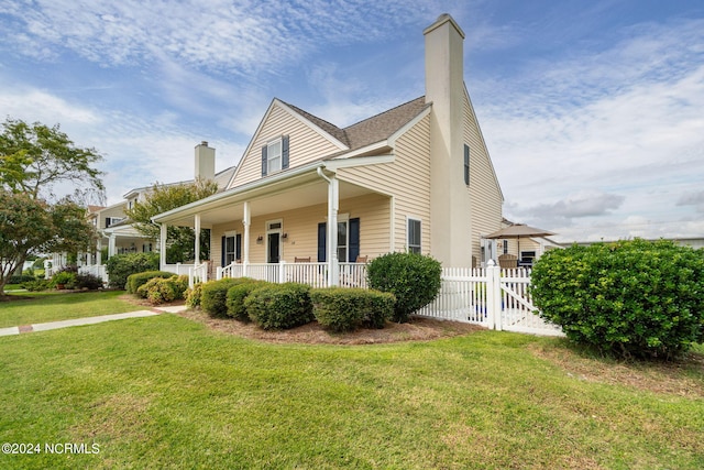 view of front of house with a front yard and a porch