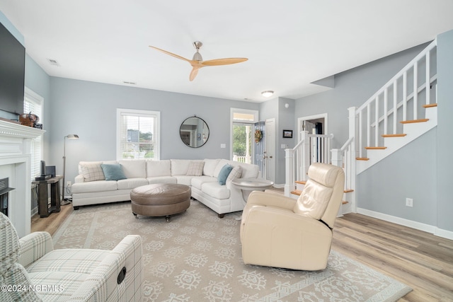 living room with ceiling fan and light hardwood / wood-style floors