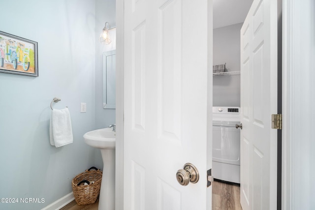 bathroom featuring washer / dryer and hardwood / wood-style floors