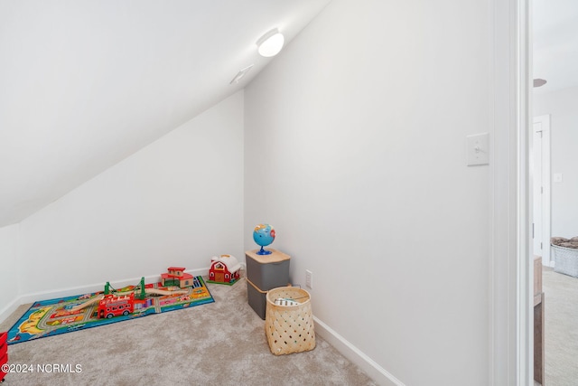 rec room with carpet flooring and vaulted ceiling