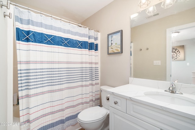 bathroom featuring vanity, toilet, and curtained shower