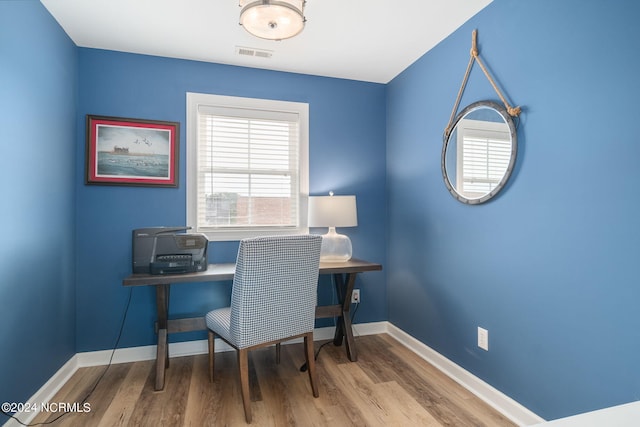 office with light hardwood / wood-style floors