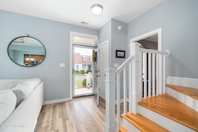 foyer featuring light hardwood / wood-style flooring and a chandelier