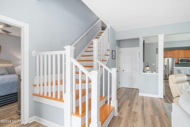 stairs with hardwood / wood-style flooring