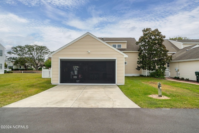 view of front of home featuring a garage and a front lawn