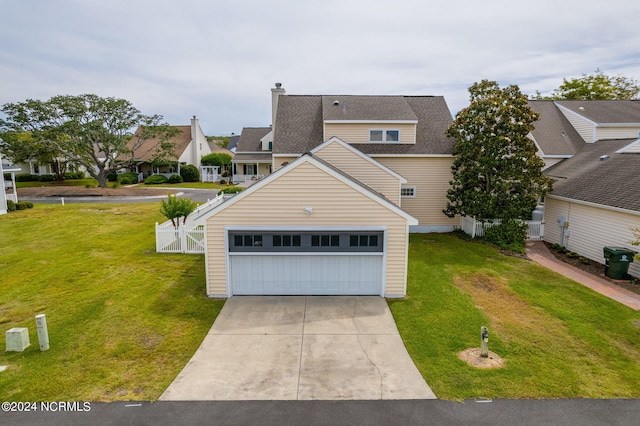 view of front of house with a garage and a front lawn