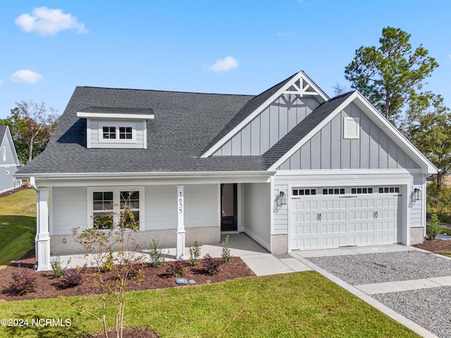1655 Old Salt Run SW Unit L-45, Shallotte, NC 28470 - view of front of property featuring an attached garage, a porch, roof with shingles, board and batten siding, and driveway