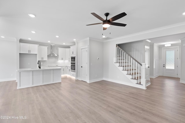 1655 Old Salt Run SW Unit L-45, Shallotte, NC 28470 - unfurnished living room featuring ceiling fan, baseboards, crown molding, light wood-style floors, and stairs