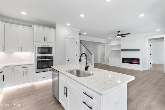 1655 Old Salt Run SW Unit L-45, Shallotte, NC 28470 - kitchen with appliances with stainless steel finishes, a sink, a ceiling fan, ornamental molding, and light wood-style flooring