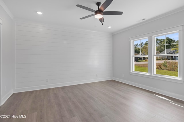 unfurnished room featuring crown molding, ceiling fan, and light wood-type flooring