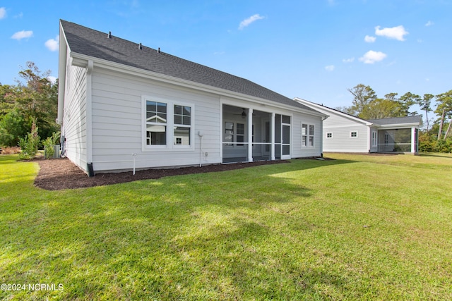 1655 Old Salt Run SW Unit L-45, Shallotte, NC 28470 - back of house featuring a sunroom, a lawn, and a ceiling fan