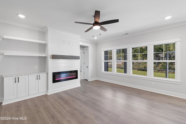 unfurnished living room with a fireplace, ornamental molding, and light hardwood / wood-style flooring