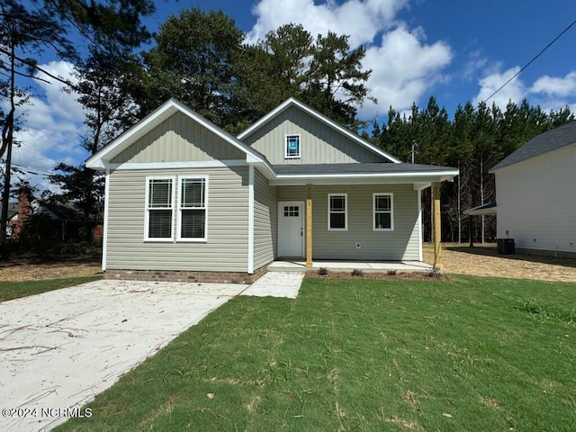 view of front of property with a front yard and central air condition unit