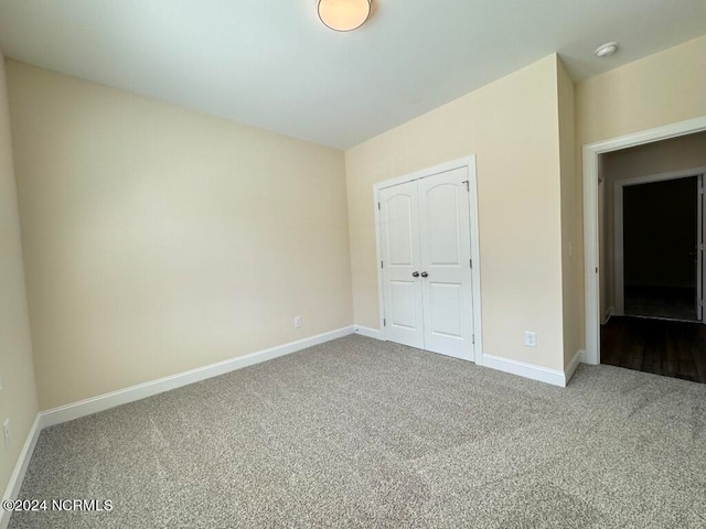 unfurnished bedroom with carpet floors and a closet