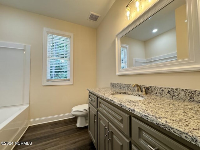 1005 Sunnybrook Rd S, Wilson, NC 27893 - bathroom with vanity, toilet, baseboards, visible vents, and wood finished floors
