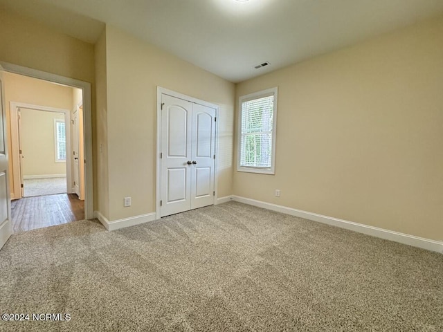 1005 Sunnybrook Rd S, Wilson, NC 27893 - unfurnished bedroom featuring baseboards, carpet, multiple windows, and visible vents