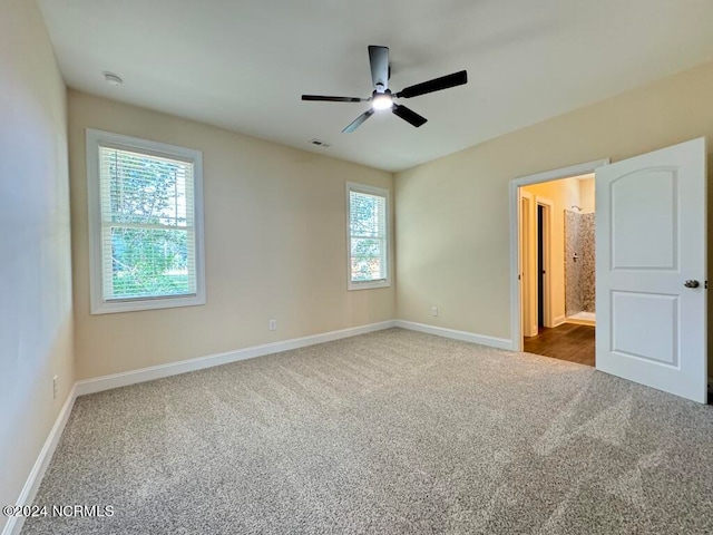 empty room featuring carpet flooring, ceiling fan, and a healthy amount of sunlight