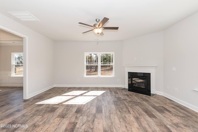 unfurnished living room with ceiling fan and dark hardwood / wood-style floors