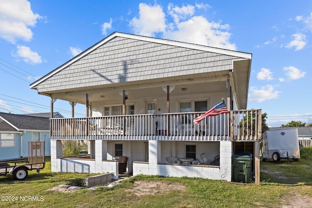 rear view of house featuring a yard