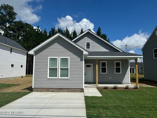 bungalow-style home with a front yard