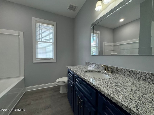 bathroom with hardwood / wood-style floors, vanity, and toilet