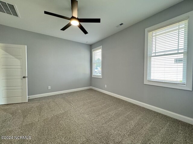 carpeted empty room with ceiling fan