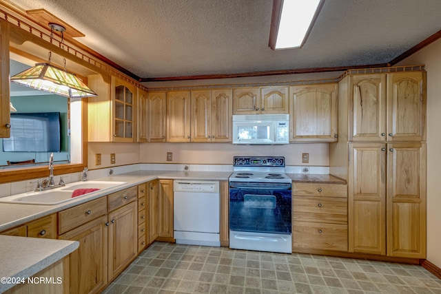 kitchen with a textured ceiling, pendant lighting, crown molding, sink, and white appliances