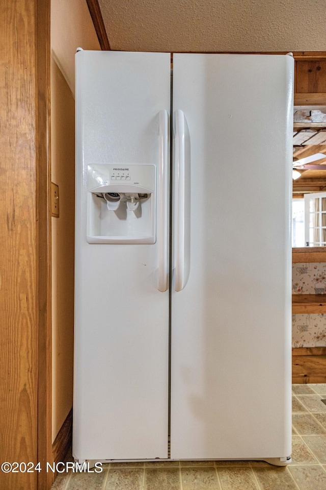 room details featuring white fridge with ice dispenser